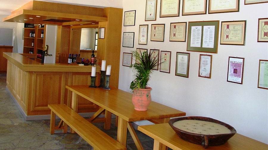 Ktima Spiropoulos tasting room with framed awards on the wall